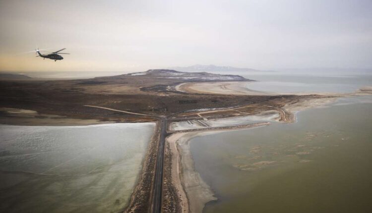 A Blackhawk helicopter flies over the Great Salt Lake as Utah lawmakers take an aerial tour of the lake with the Utah Army National Guard on Feb. 15. Utah experts project the lake will fall another 2 feet below the record low set last year.