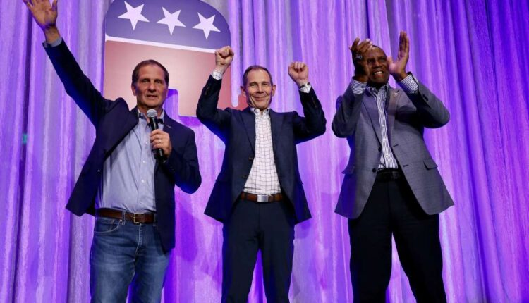 Rep. John Curtis R-Utah, Rep. Chris Stewart, R-Utah and Rep. Burgess Owens R-Utah, take the stage at an election party at the Hyatt Regency in Salt Lake City on Tuesday. 