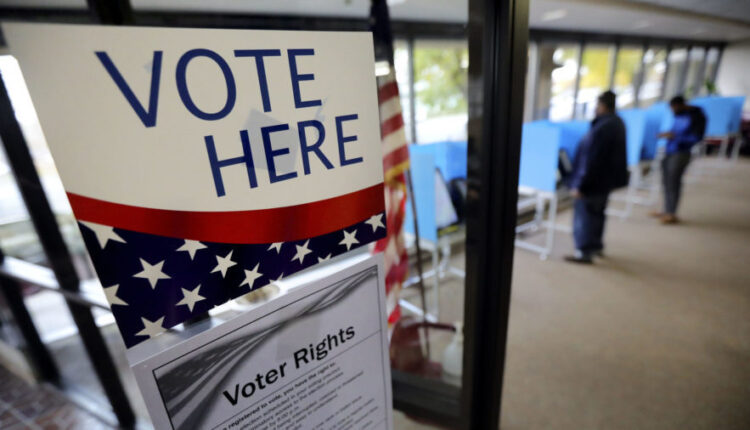 Leo Romero and Yohanes Frezgi, both of Salt Lake City, vote at the Salt Lake County Government Cent...