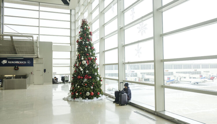 Holiday travelers crowd the Detroit Wayne County Metro Airport on Christmas Eve following Winter St...