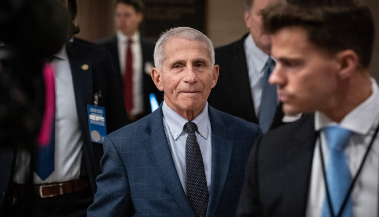 A photo of Anthony Fauci walking inside the U.S. Capitol.